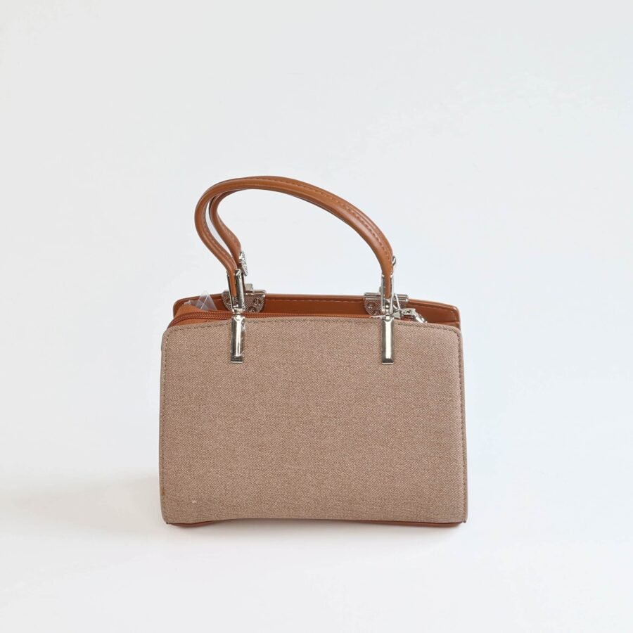 Sac à main en toile beige avec poignées en cuir marron, parfait pour un style chic et fonctionnel..